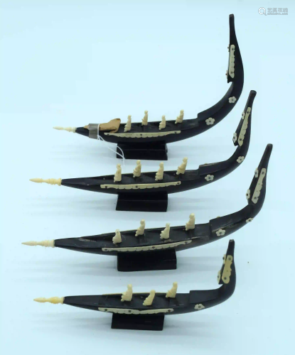 A group of carved wooden boats with African bone