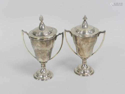 A near pair of silver trophy cups and covers