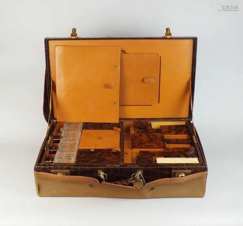 An early 20th century crocodile vanity case