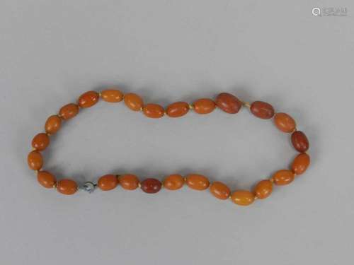 A graduated amber bead necklace