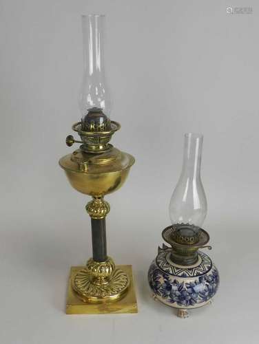 A brass candlestick oil lamp and another earthenware example. (2)