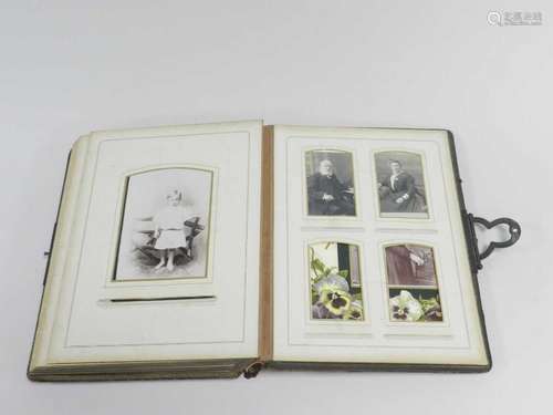 An Edwardian photograph album, leather bound, the leaves printed with flower sprays and gilt-edged