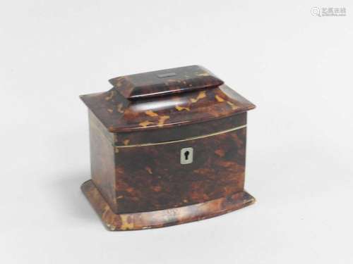 A 19th century tortoiseshell tea caddy, of casket form, the hinged cover opening to a single