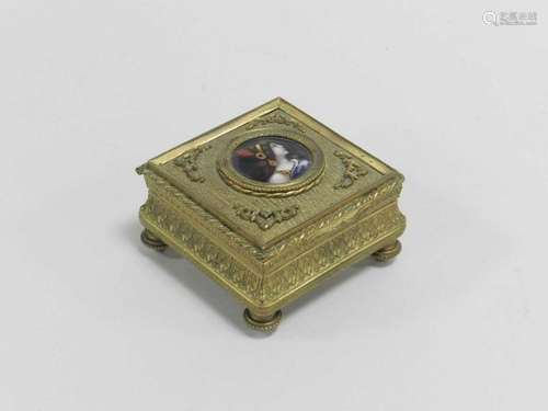 A 19th century French gilt metal jewellery box, the cover inset with an enamel bust portrait of a