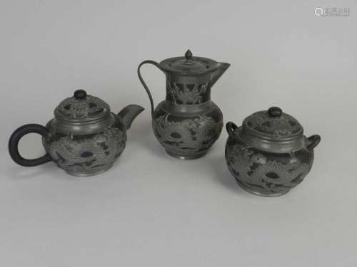 A Chinese pewter mounted Yixing pottery three-piece tea set, worked with dragons, together with a