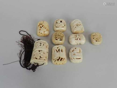 A group of Japanese carved bone okimono, netsuke and an inro, late Meji period. (9)