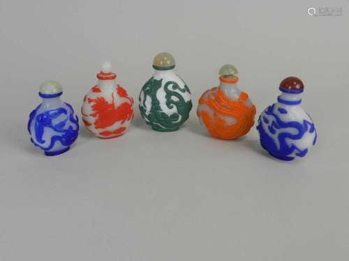 Six Chinese cameo glass snuff bottles, 20th century, each of ovoid form and worked with dragons,