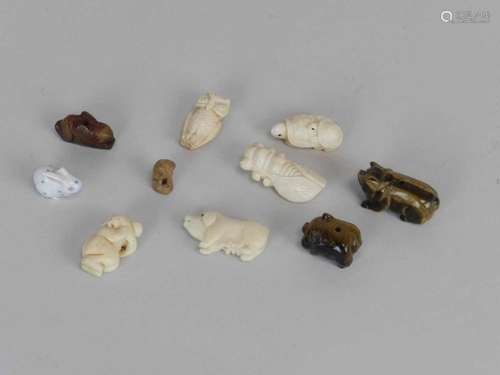 A group of small Chinese and other carved bone and tigers eye animal figures and beads, circa