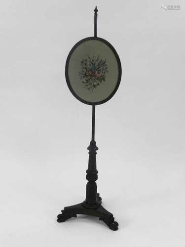 A Victorian rosewood pole screen, the oval screen with needlepoint worked with a flower spray, the