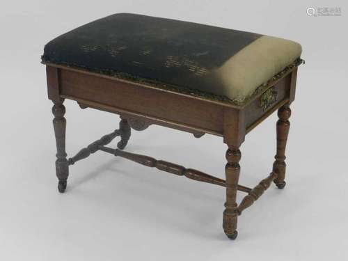 An Edwardian oak piano stool, with upholstered seat and aesthetic-movement influence aprons,