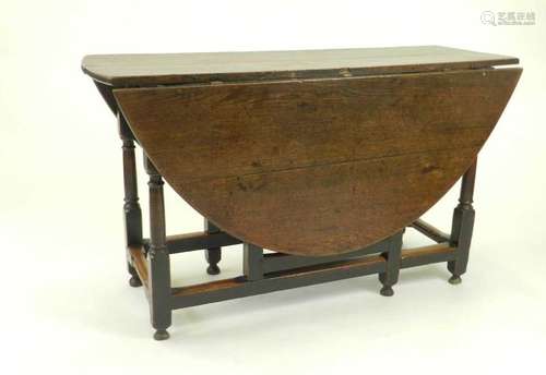 A 19th century oak gateleg drop-leaf table, the plain oval top raised on turned supports, 122cm