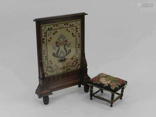 An Edwardian oak-framed fire screen, inset with a woolwork of stylised flower forms, 78cm x 58cm,