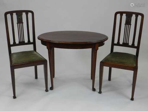 A reproduction mahogany occasional table, of oval form and raised on tapering supports with pad