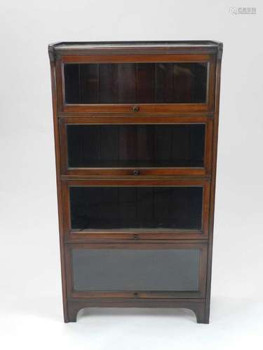 An Edwardian four-tier glazed bookcase, 72cm wide, 135cm high, 30cm deep.