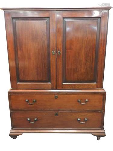 An early 19th century mahogany linen press, the moulded top above twin panelled doors opening to