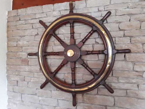 A brass bound teak ship's wheel, with wall fixing bracket and brass center cap, 94cm dia.