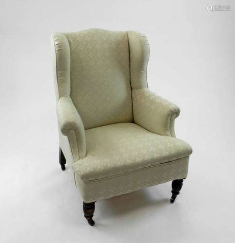 A late Victorian mahogany framed upholstered wing armchair, with recent cream brocade fabric, the