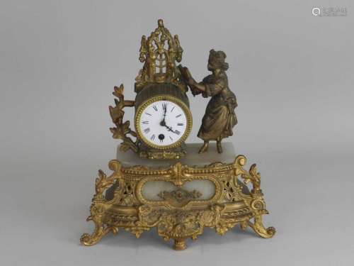 A French gilt metal and alabaster mantel clock, the fluted barrel beside a maiden reading from a