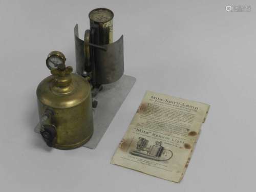 A Mita Lilliput Reford light with wing nut pressure valve and gauge above a brass fuel chamber,