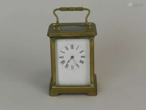 A French brass carriage timepiece, first half 20th century, of typical form, the white enamel dial