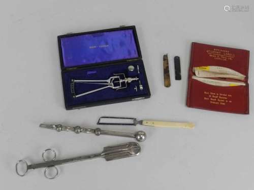 A group of 19th/20th century medical implements, including a white metal prinking syphon, a