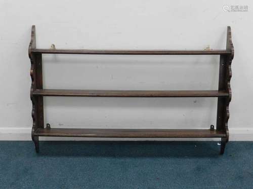 A 19th century joined oak mural delft rack, having three shelves between shaped uprights, 130cm