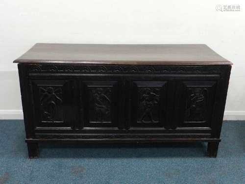 A carved oak quadruple panel coffer, 17th/18th century, the moulded top probably later, above a