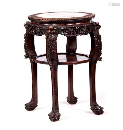 A 19TH CENTURY PROFUSELY CARVED CHINESE HARDWOOD CIRCULAR JARDINIERE STAND with marble inset top and