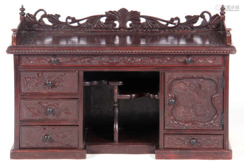 A 20TH CENTURY ORIENTAL CARVED TABLE TOP DESK with pierced gallery back above a greek key carved