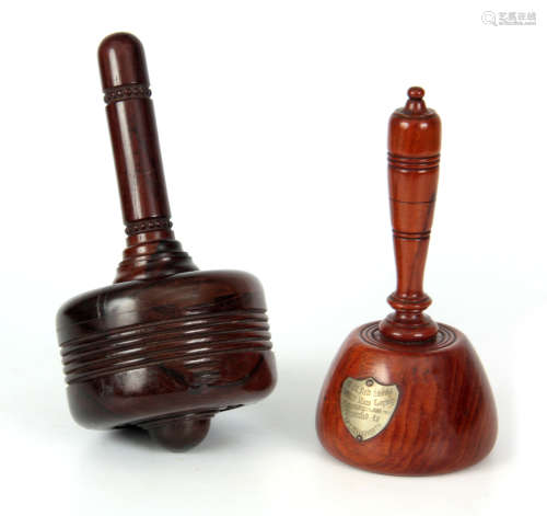 TWO EARLY 20TH CENTURY TURNED TREEN MALLETS comprising a Walnut example with metal shield-shaped