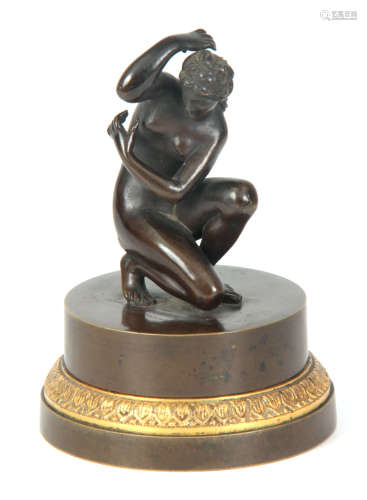 AN UNUSUAL 19TH CENTURY BRONZE INKWELL depicting a bronze sculpture of a nude lady revealing a