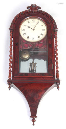 A 19TH CENTURY AMERICAN FIGURED MAHOGANY WALL CLOCK with carved pediment and barley twist columns