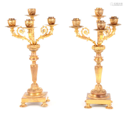 A PAIR OF LATE 19TH CENTURY ORMOLU GILT BRASS FOUR BRANCH CANDELABRA with leaf cast decoration and
