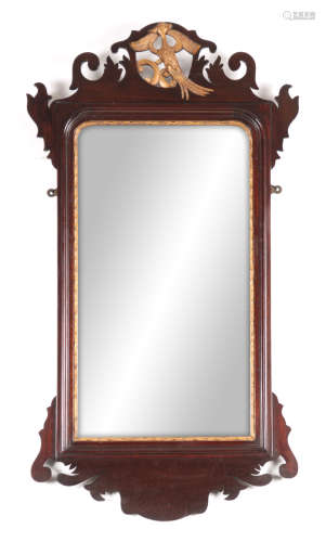 A 19TH CENTURY GEORGE III STYLE MAHOGANY HANGING MIRROR with a shaped frame having gilt carved