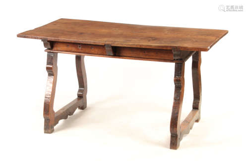 AN 18TH CENTURY SPANISH WALNUT TABLE with plank top above shaped end supports 145cm wide 80cm deep