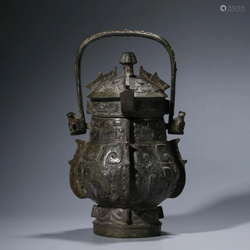 A CHINESE BRONZE WINE VESSEL WITH COVER