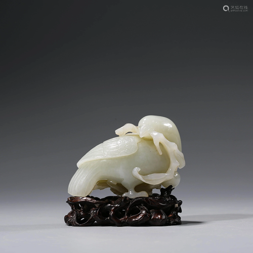 A CHINESE WHITE JADE BIRD WITH STAND