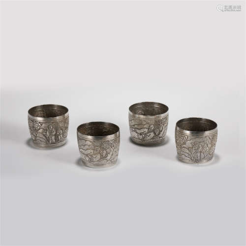 FOUR SILVERWARE CUPS CARVED FIGURE STORY MOTIF