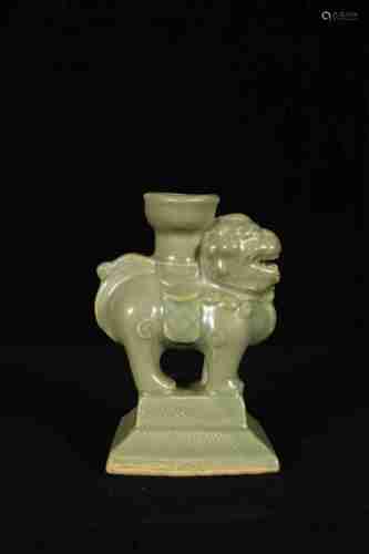 A CHINESE LONGQUAN KILN CANDLESTICK DESIGNED WITH AUSPICIOUS BEAST, YUAN DYNASTY