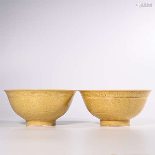 Qing Yongzheng yellow glaze dark engraving baby play picture bowl pair