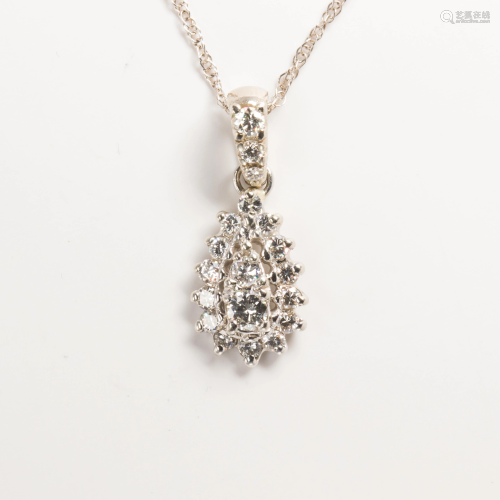A diamond and fourteen karat white gold pendant