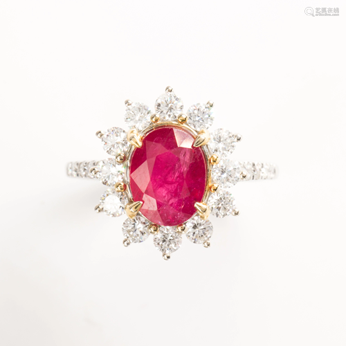 A ruby, diamond and fourteen karat white gold ring