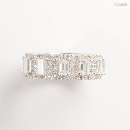 A diamond and eighteen karat white gold band ring