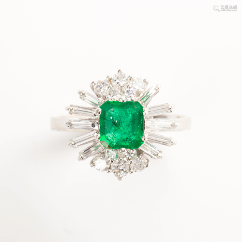 An emerald, diamond and eighteen karat gold ring