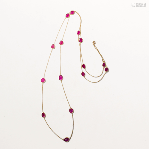 A ruby and fourteen karat gold necklace