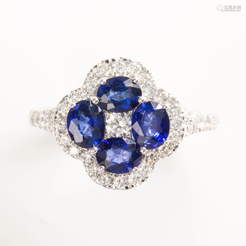 A sapphire, diamond and fourteen karat white gold ring