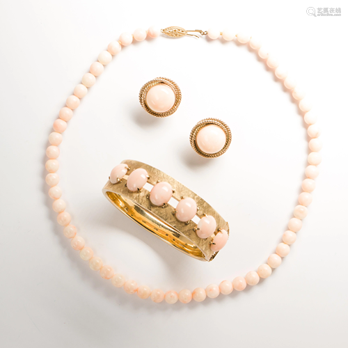 A group of angel skin coral and fourteen karat gold