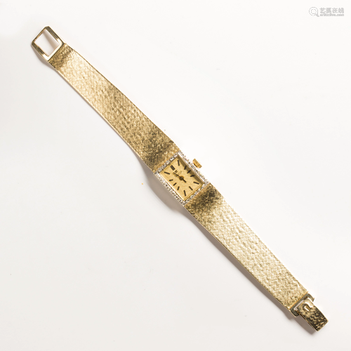 A diamond and fourteen karat yellow gold wristwatch,