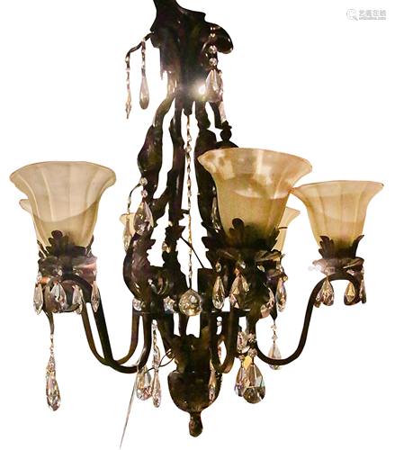 A wrought metal and glass six arm chandelier