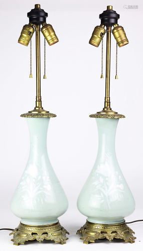 A pair of gilt bronze mounted pate sur pate porcelain